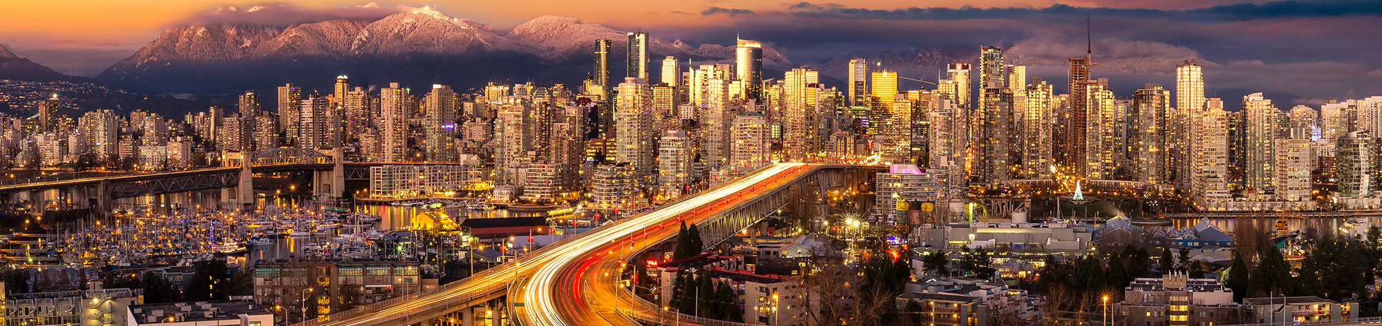 Vancouver Sunset Aerial Panoramic view of Downtown Vancouver, Cambie Bridge, and False Creek.